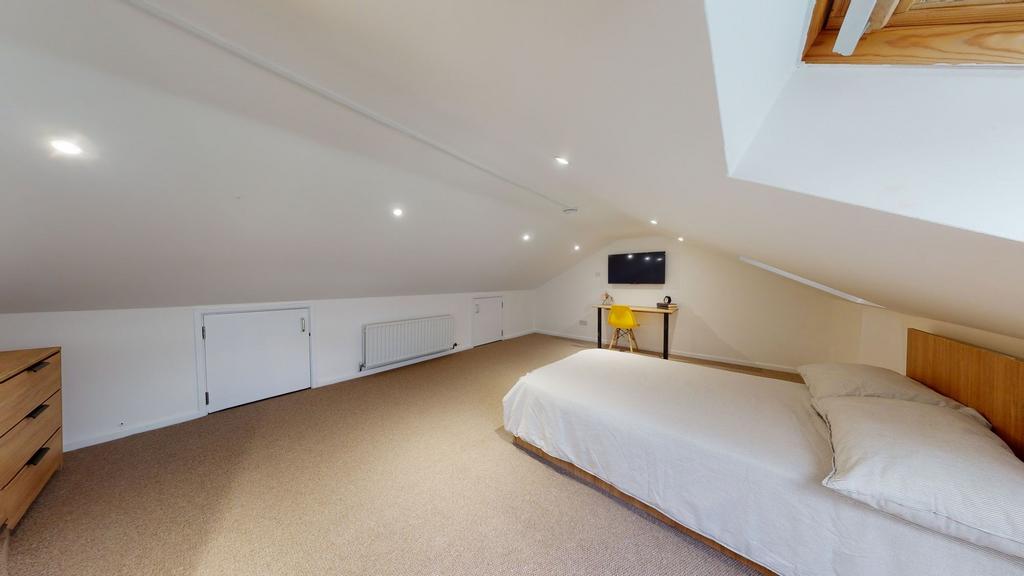 Bright and spacious attic-style living room wit...