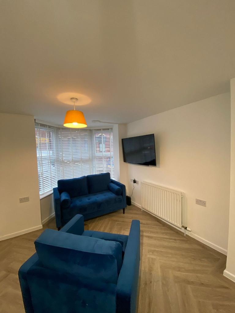 A bright and welcoming living room featuring th...