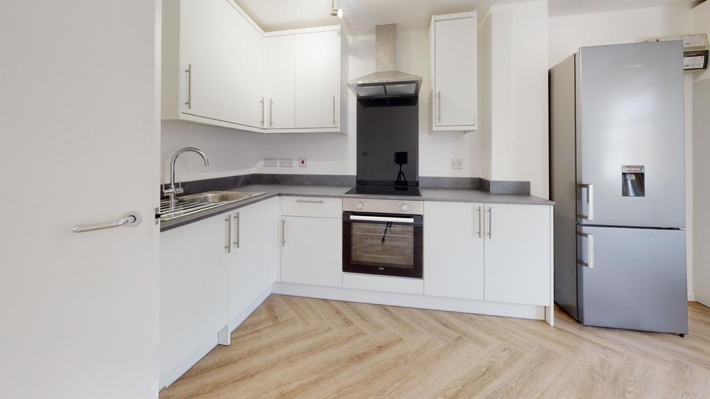 Modern and clean kitchen with white cabinets, s...