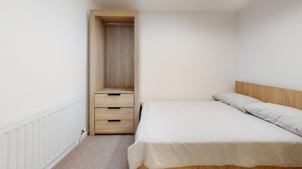 A spacious, well-maintained master bedroom feat...