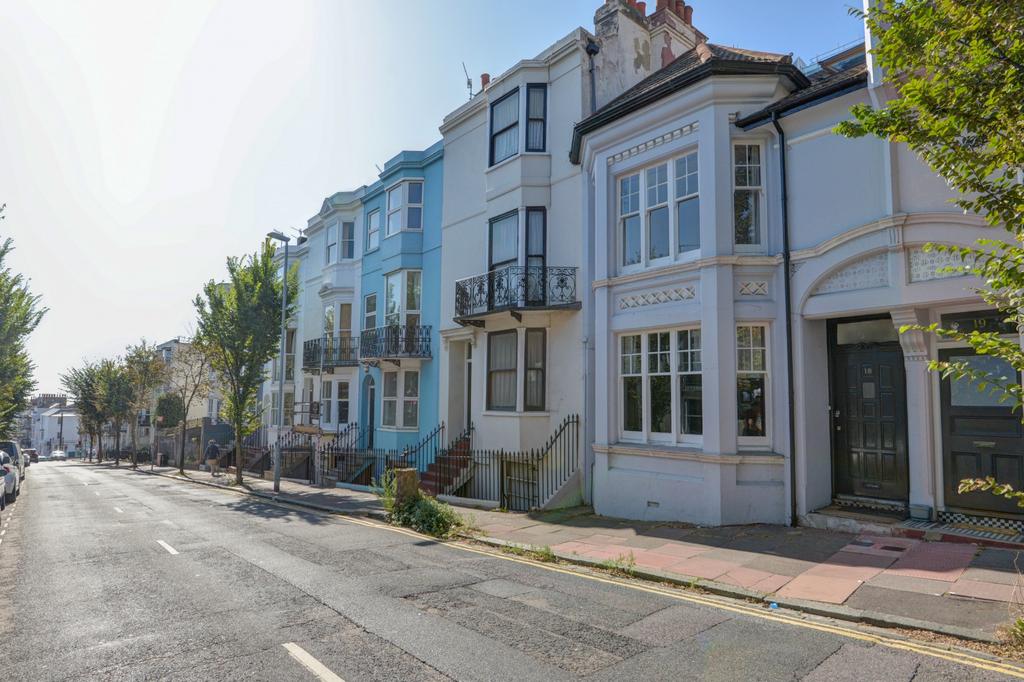 A charming row of terraced houses bathed in nat...