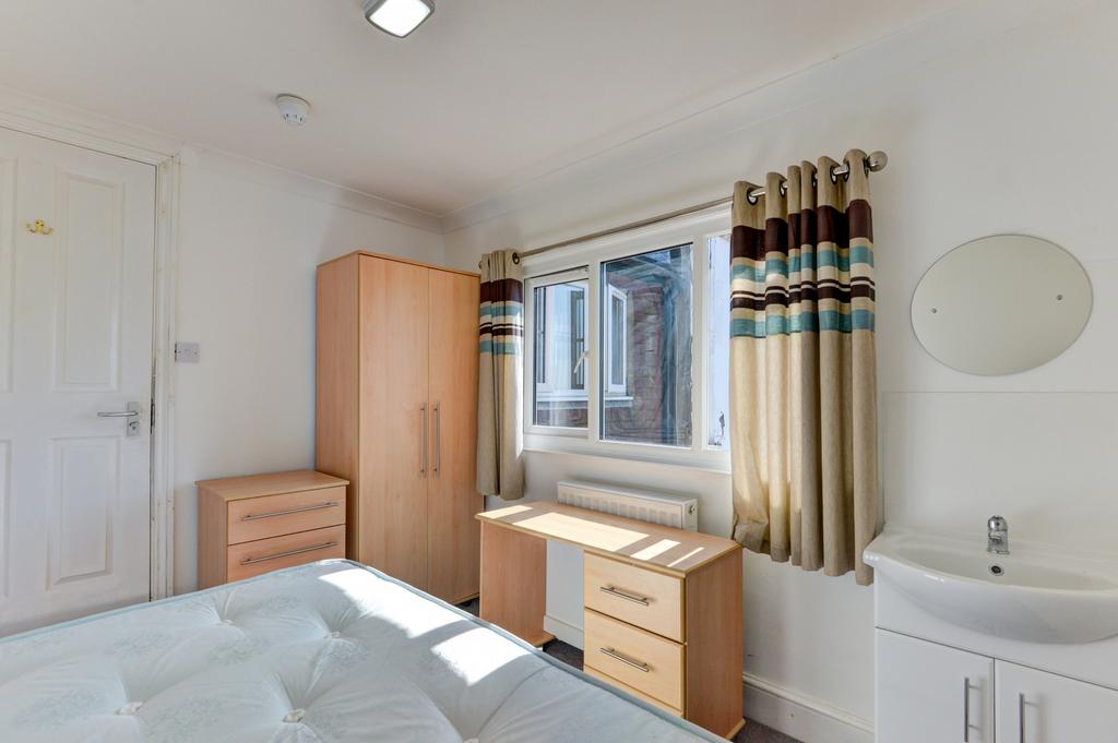 Bright and clean single toilet room featuring a...