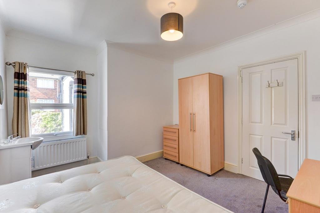 Bright and tidy double bedroom featuring a comf...