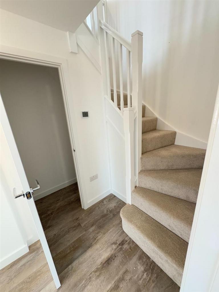 Stairs to the first floor and storage
