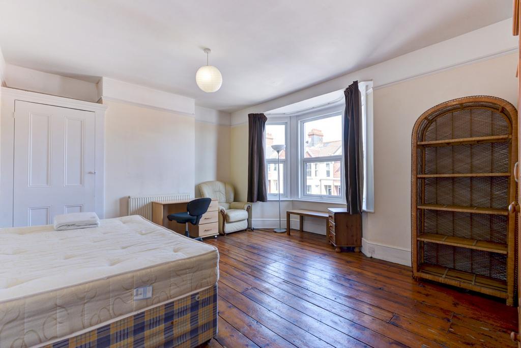 Spacious master bedroom with large windows prov...