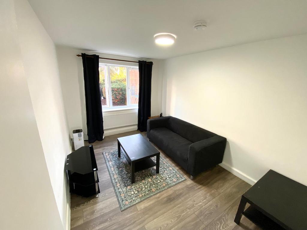 Bright, freshly painted living room with a larg...