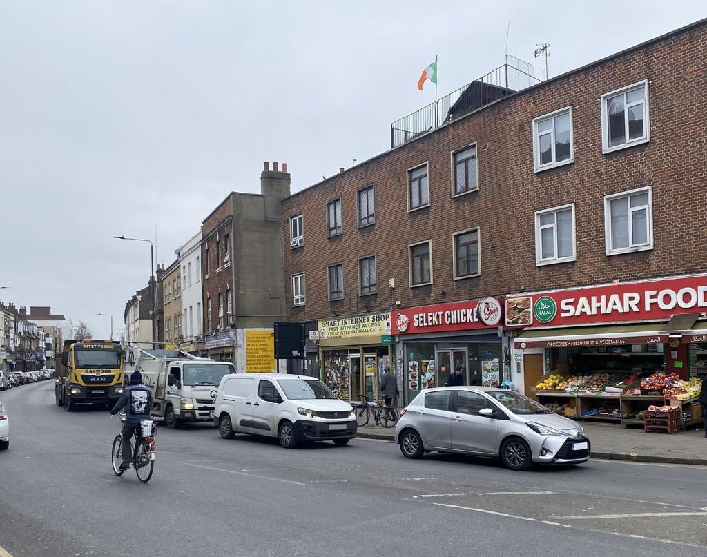The image displays a street scene outside a mix...