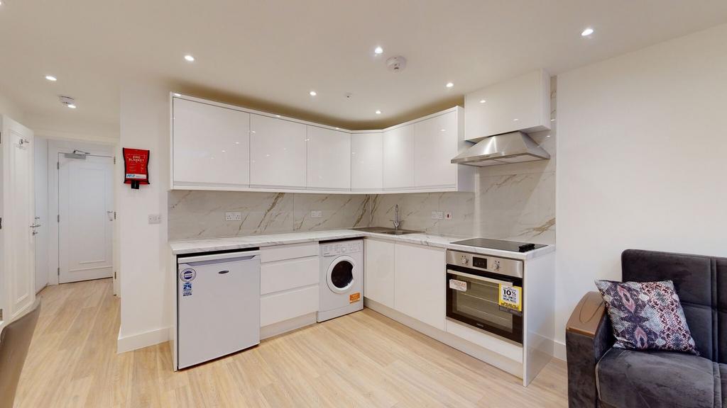 Modern kitchen with sleek white cabinets, integ...