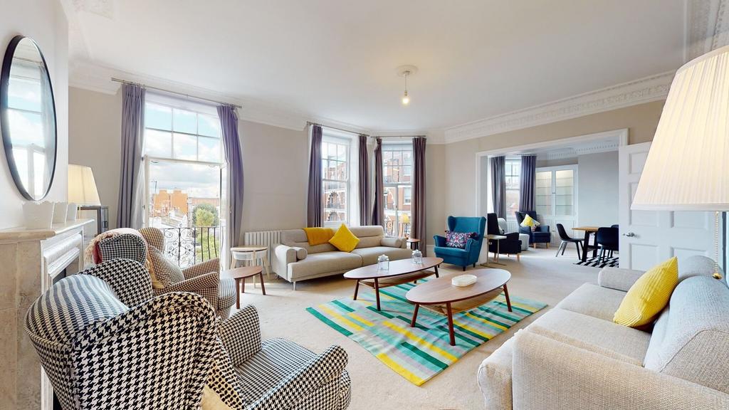 A spacious and stylish living room featuring la...