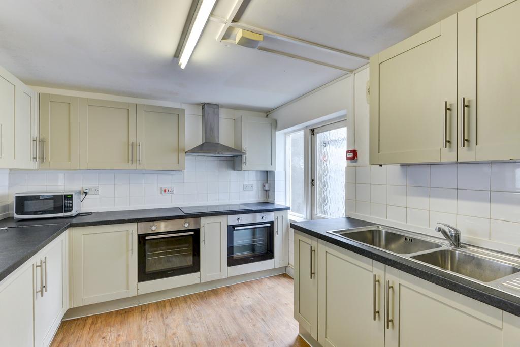 Bright and clean kitchen featuring modern cabin...