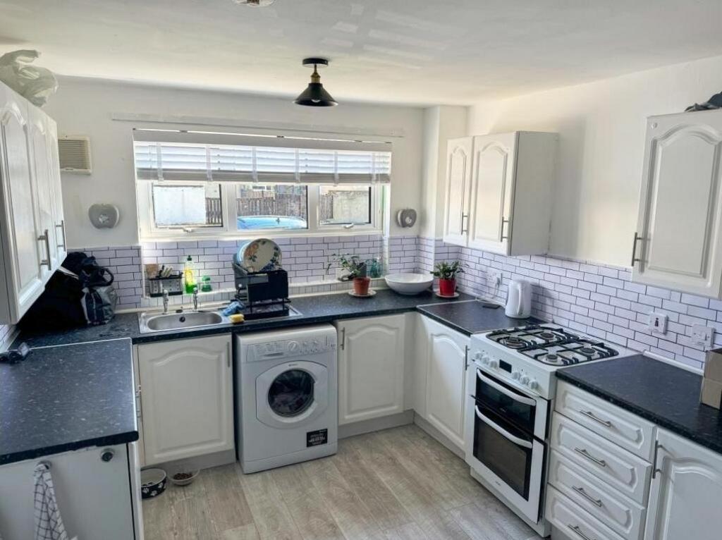 Bright and tidy kitchen with ample counter spac...