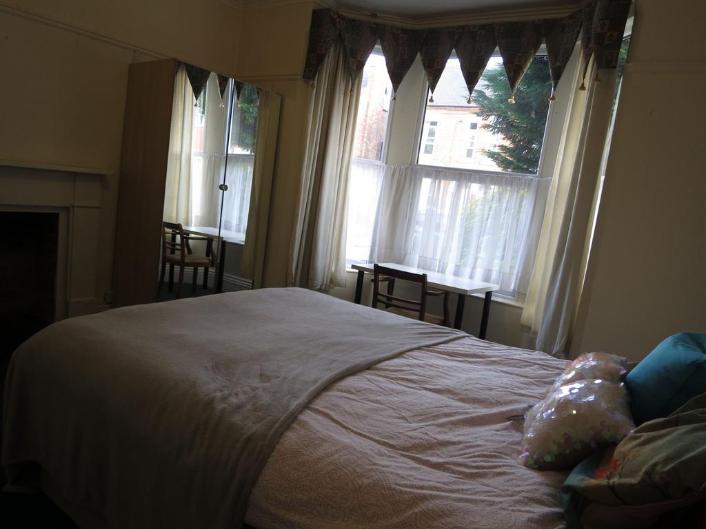 A cozy bedroom with a large window allowing nat...