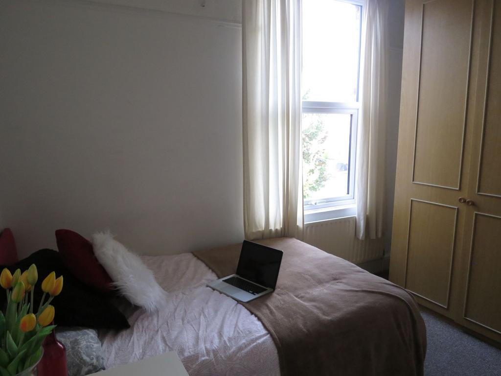 A cozy, well-maintained double bedroom with a c...