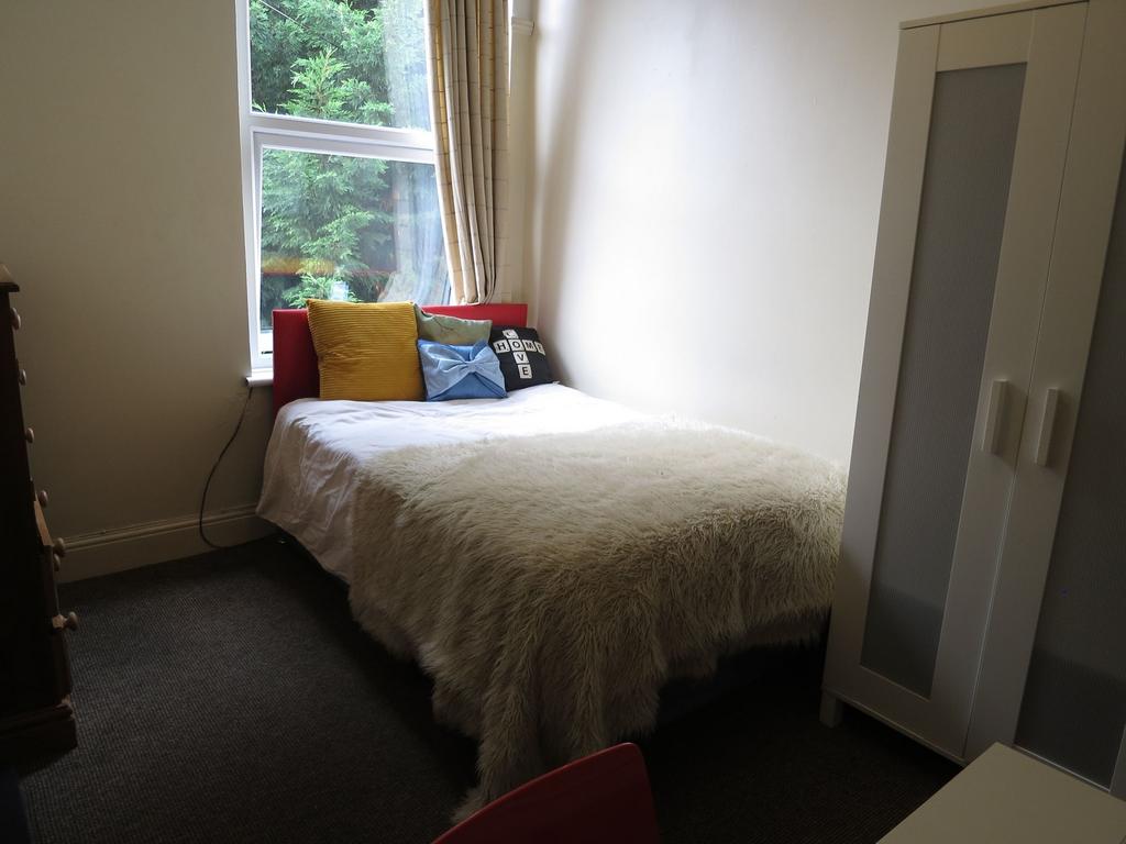A cozy, well-maintained bedroom featuring a com...
