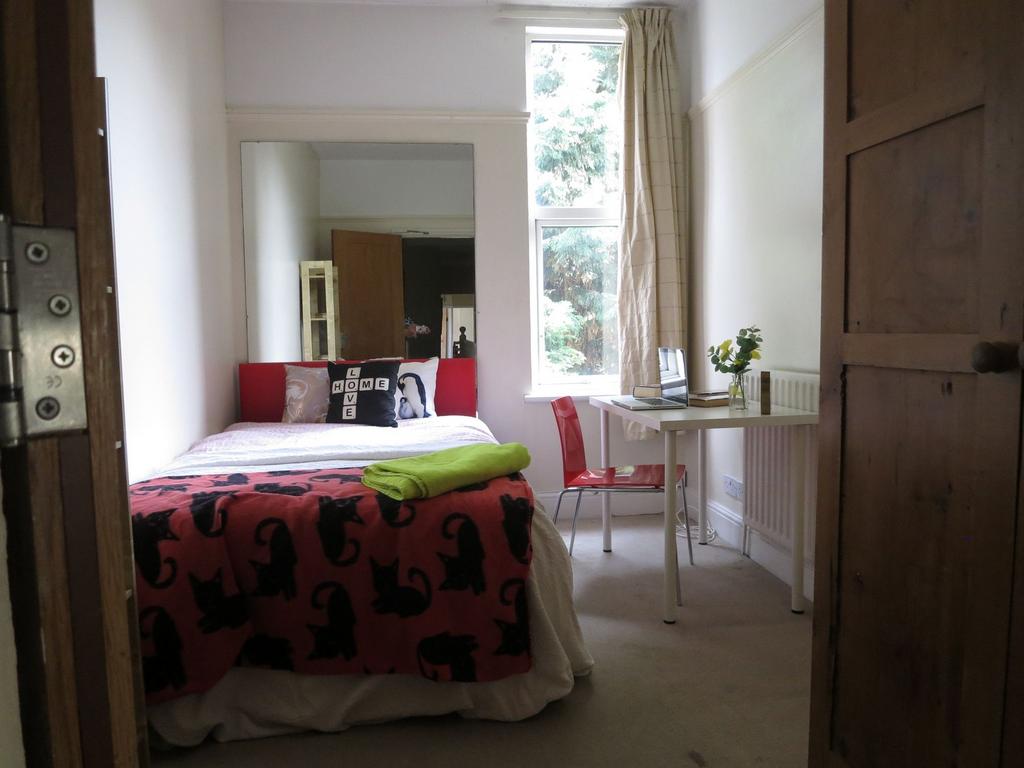 Bright and welcoming master bedroom featuring a...
