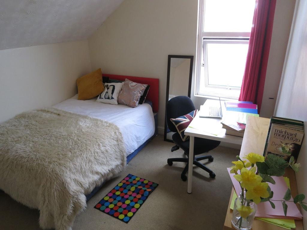 Cozy bedroom with a comfortable bed adorned wit...