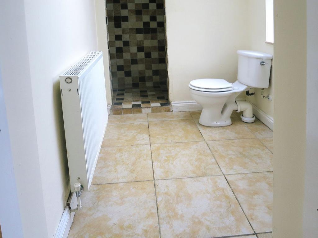 Clean and functional bathroom featuring a toile...