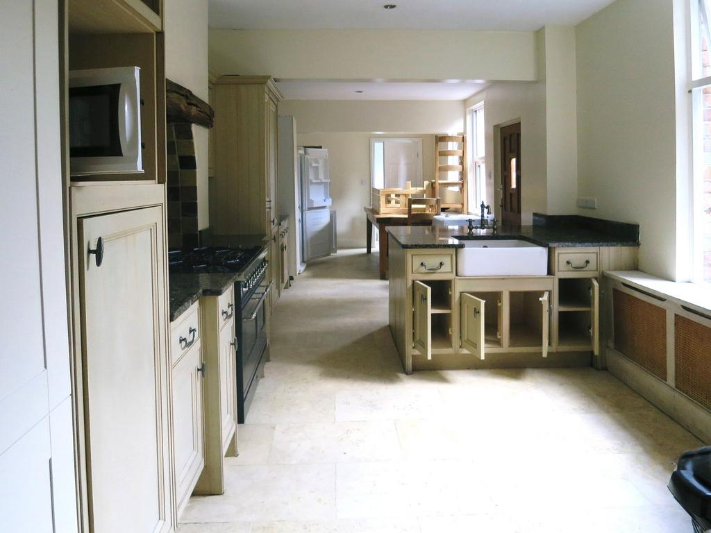 A spacious kitchen with a classic design featur...