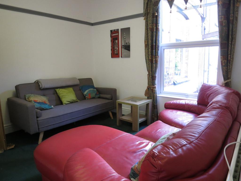 A bright, welcoming living room featuring a lar...
