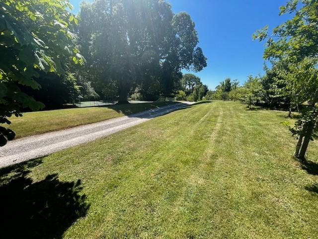 Grounds with tennis court in the distance