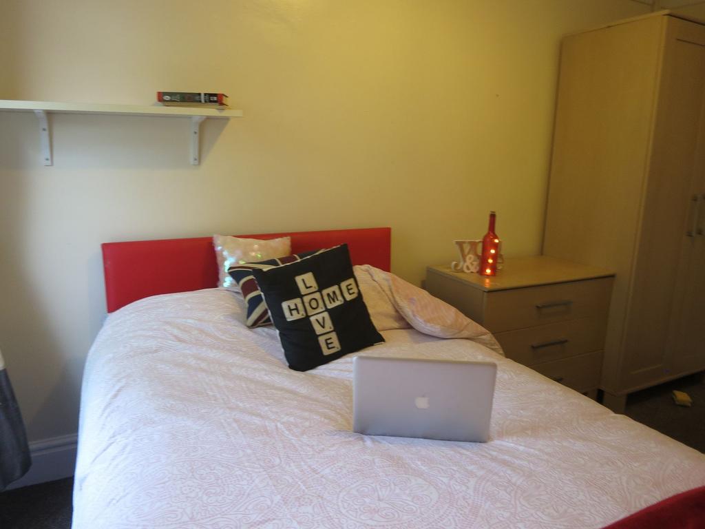 Cozy double bedroom featuring a neatly made bed...