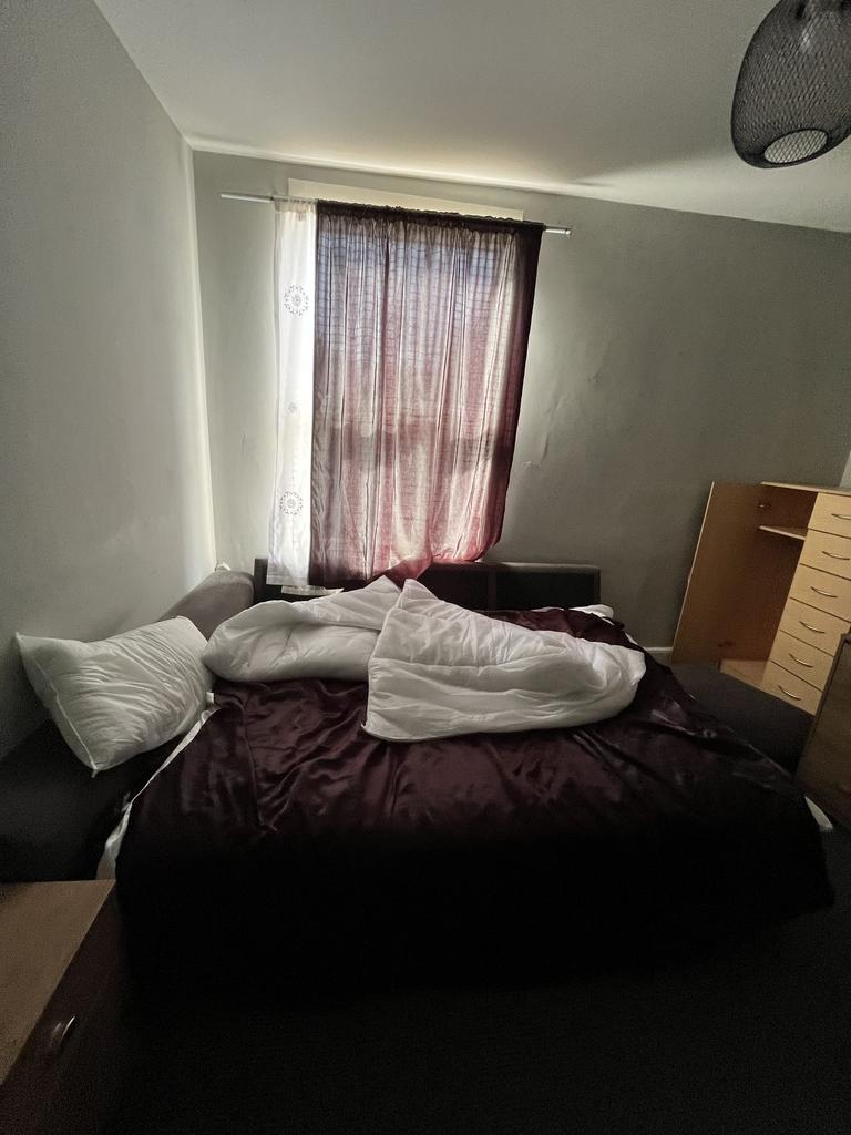 A cozy bedroom featuring a neatly made bed with...