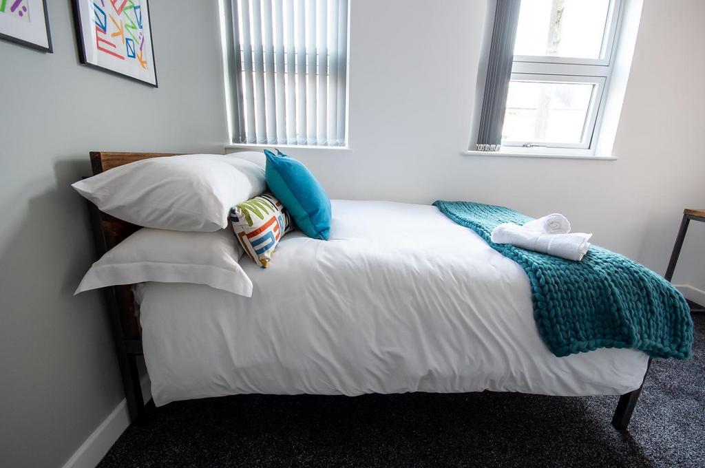 A bright and welcoming double bedroom featuring...