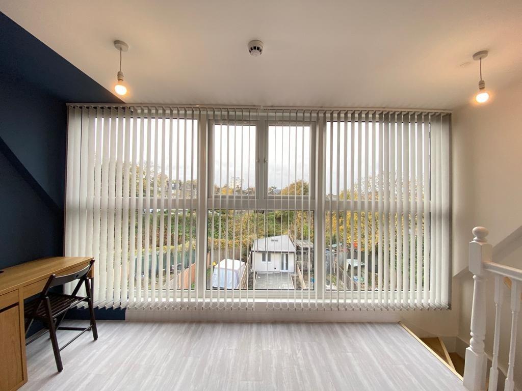 A bright and welcoming view of the front of a r...