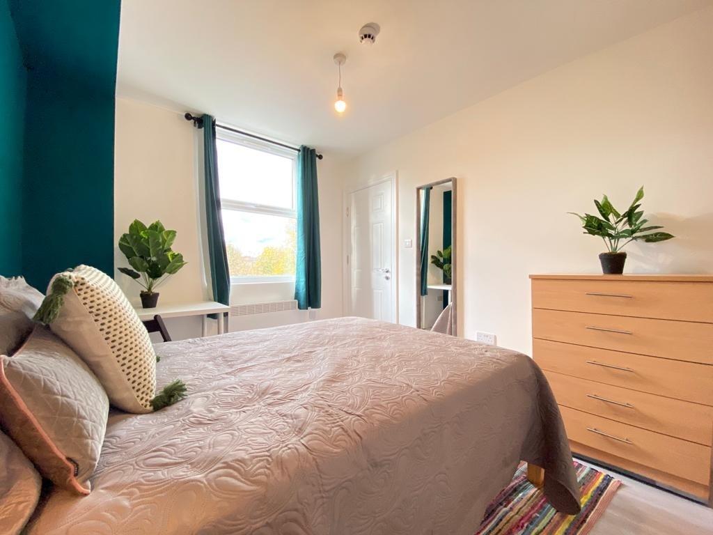 Bright and welcoming bedroom featuring a large ...