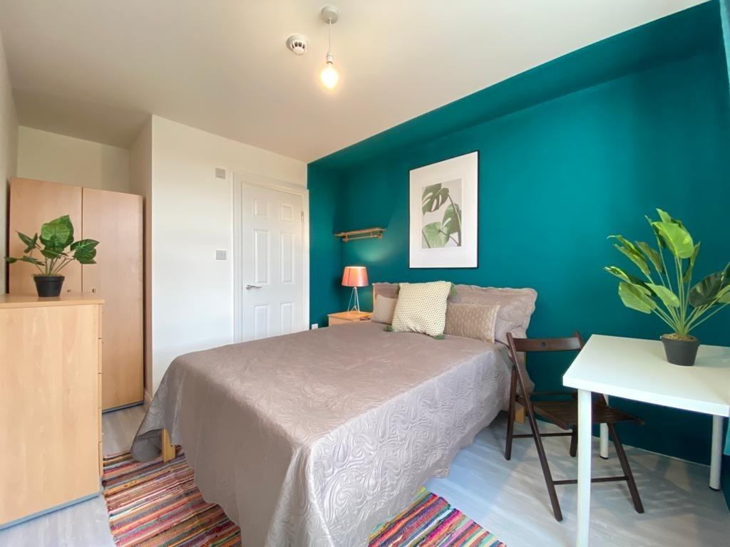 Bright and inviting double bedroom with stylish...