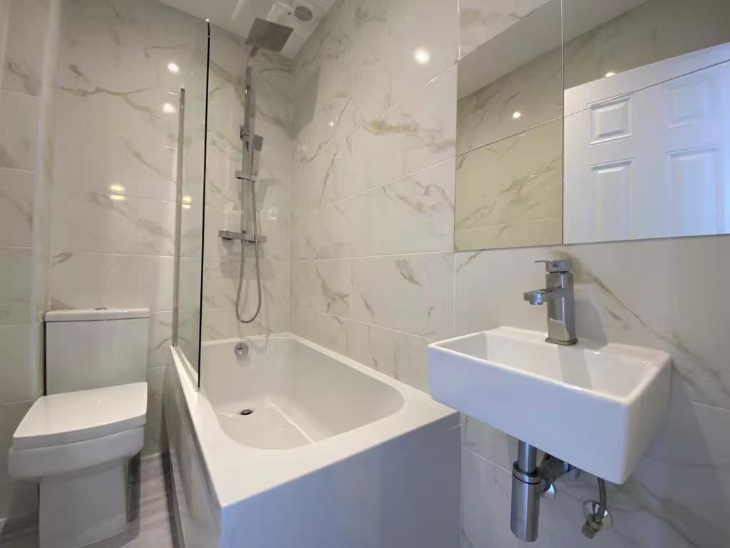 Modern and sleek bathroom featuring a spacious ...