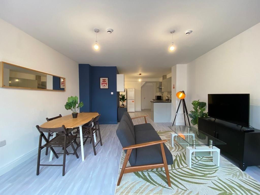 Modern and spacious living area featuring a com...