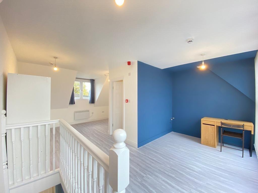 Bright, freshly painted upstairs bedroom with a...