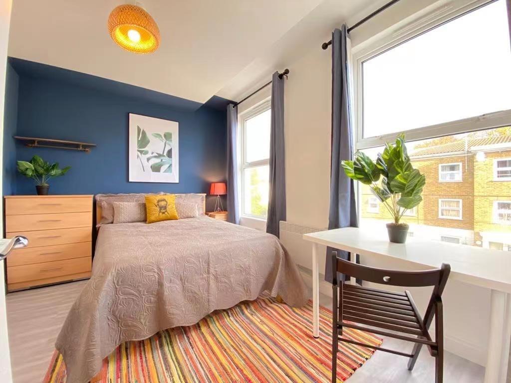 Bright, welcoming bedroom with modern decor, fe...