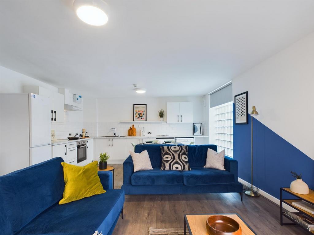 A spacious and stylish modern living room featu...