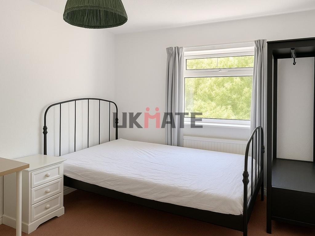 Bright and welcoming bedroom with a comfortable...