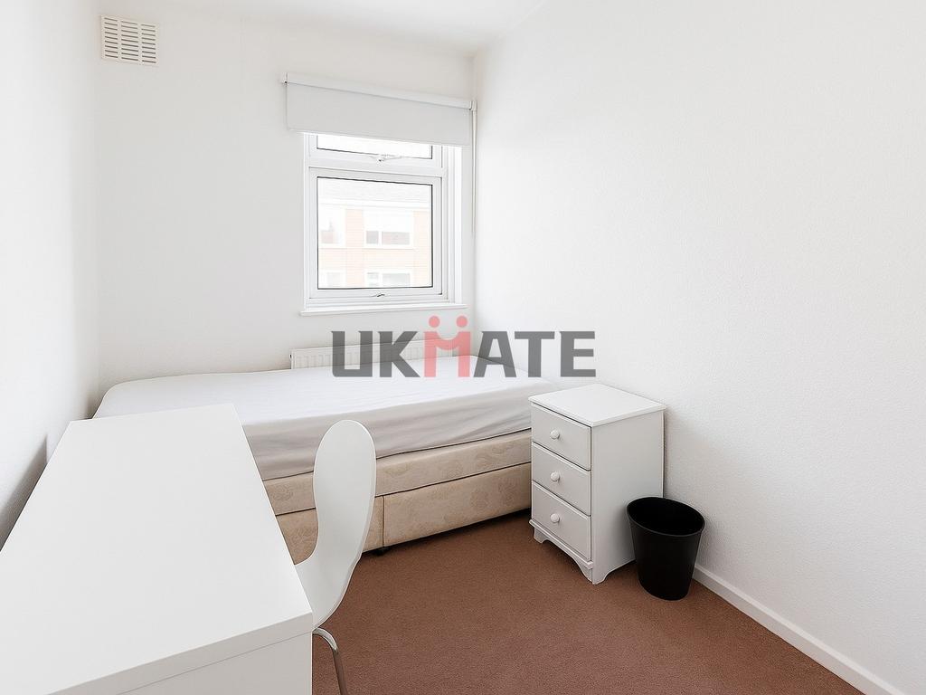 A bright and tidy small bedroom featuring a sin...