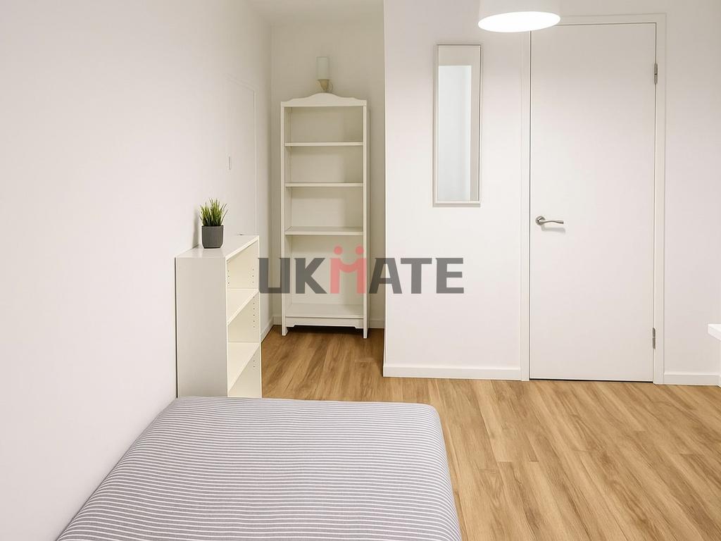 Bright and clean bedroom featuring a comfortabl...