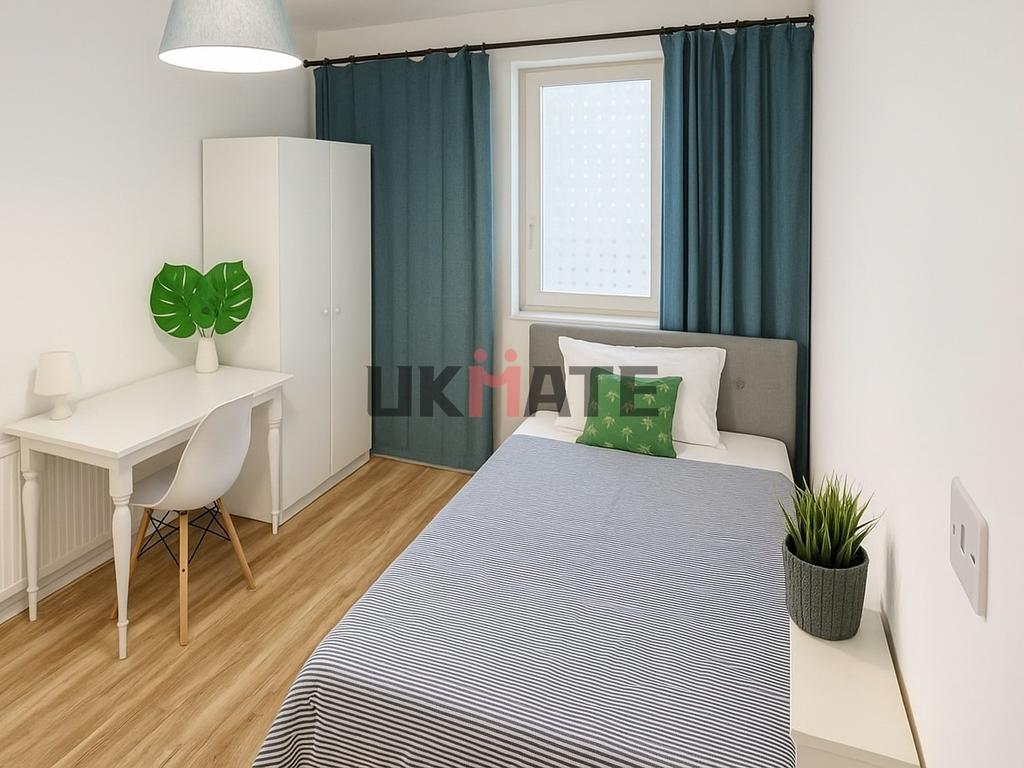A bright and tidy bedroom featuring a comfortab...