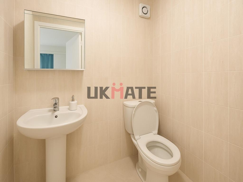 Bright and clean bathroom featuring a modern to...