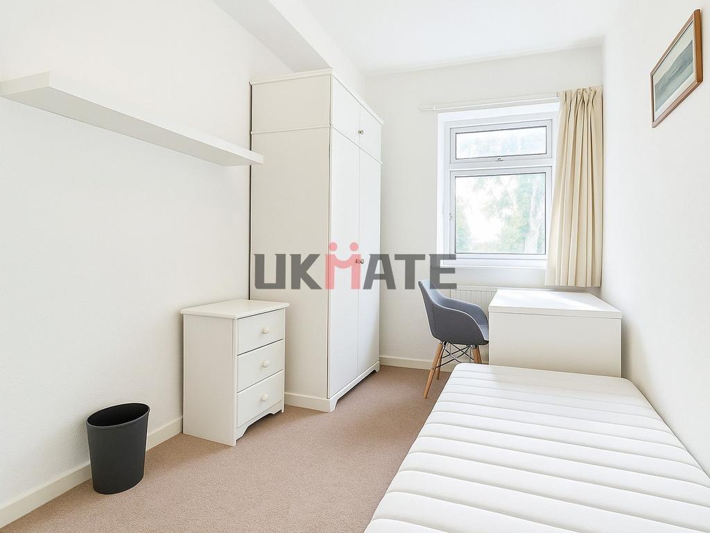 A bright and tidy single bedroom featuring a co...
