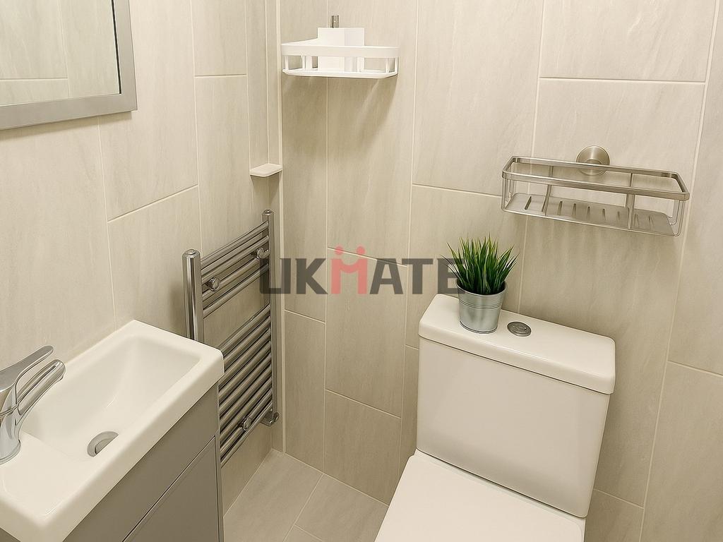 A modern, clean bathroom featuring a white toil...