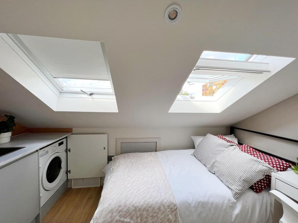 Bright and cozy double bedroom with large skyli...