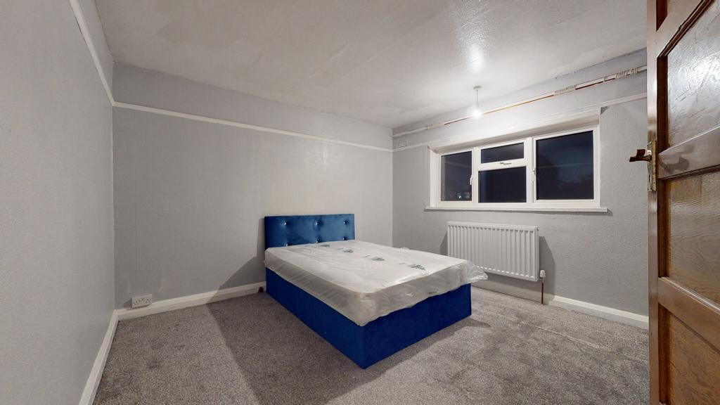 A spacious and well-lit master bedroom featurin...