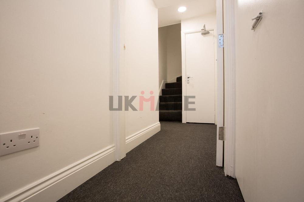 Bright, well-maintained hallway with neutral de...