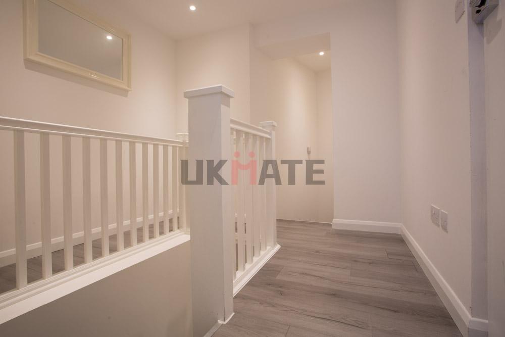 Bright, freshly painted hallway with modern woo...