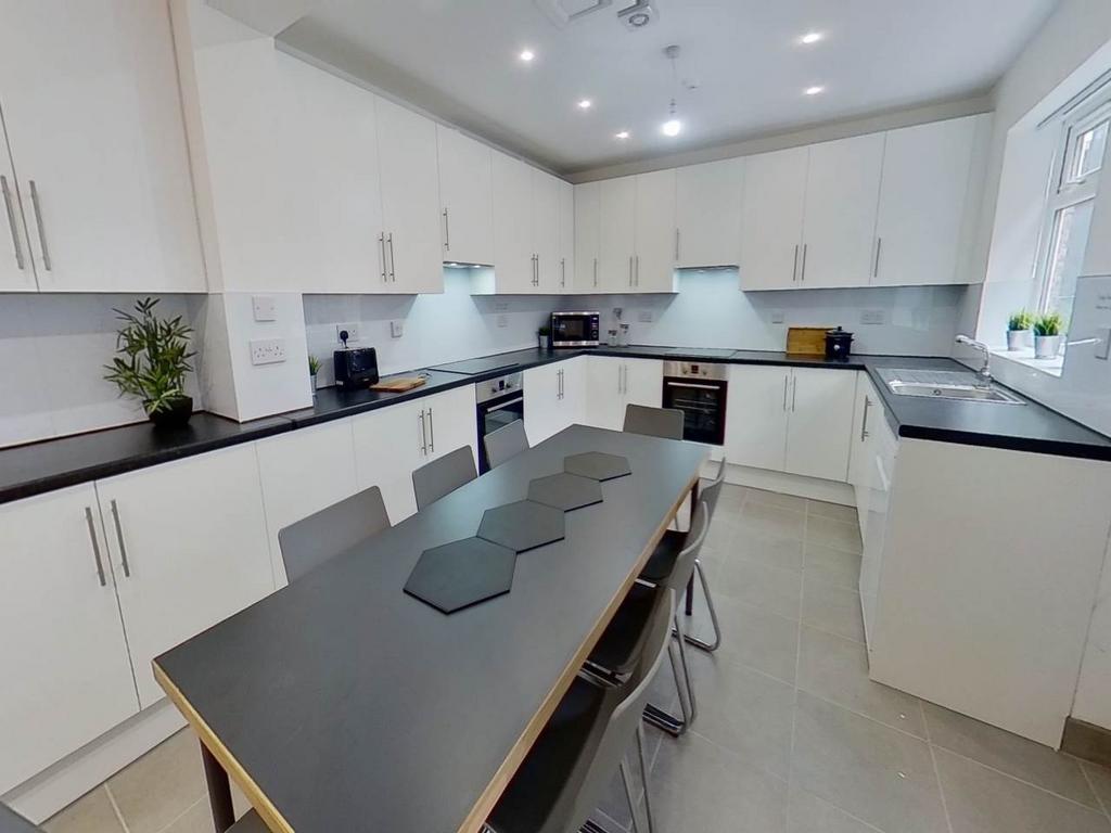A bright, modern kitchen with ample counter spa...