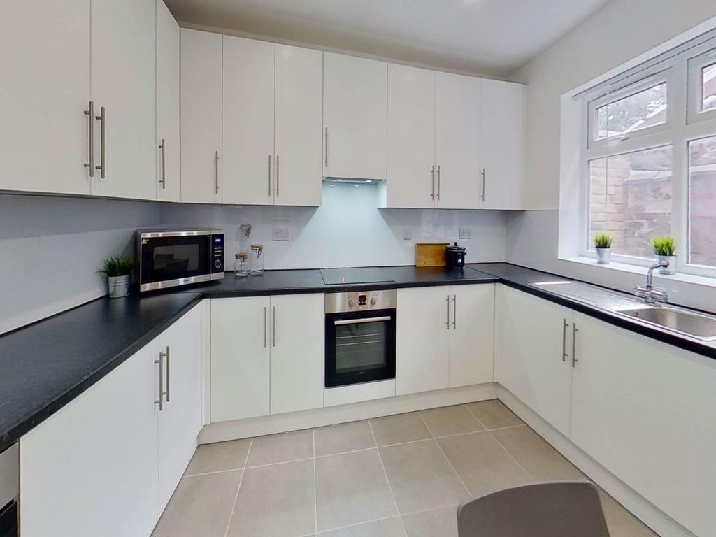 A bright, modern kitchen with clean white cabin...