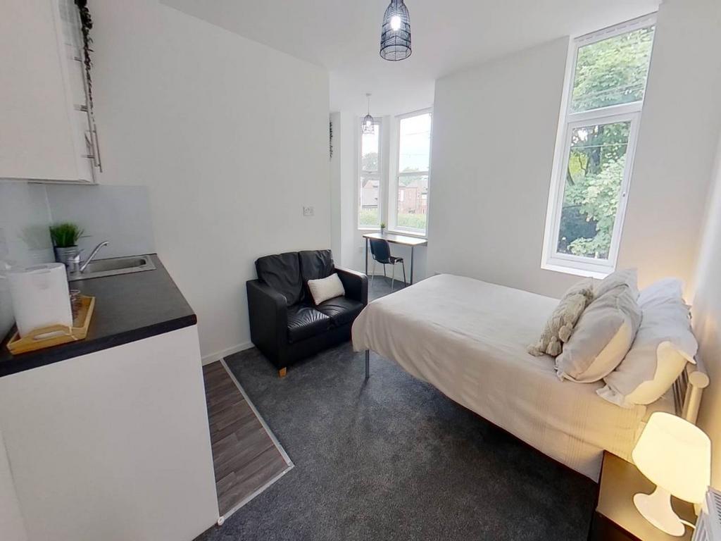 A bright and inviting bedroom with large window...
