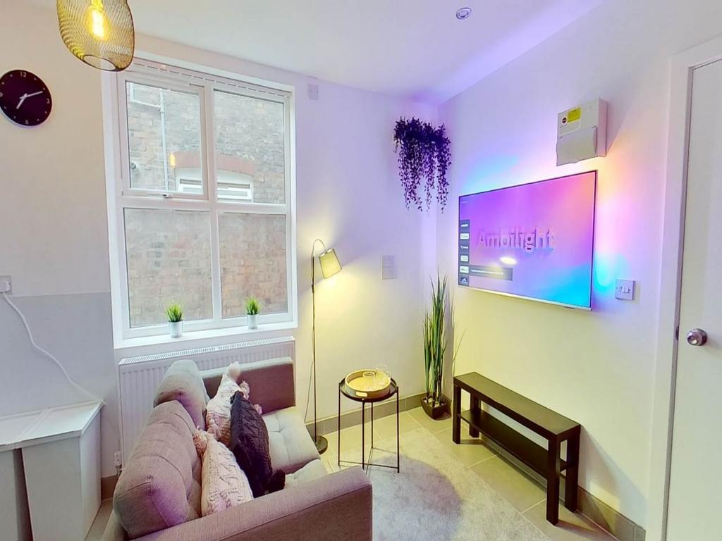 A bright and inviting living room featuring com...